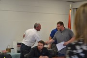Mr. Schneider shaking Mr. Heideman's hand